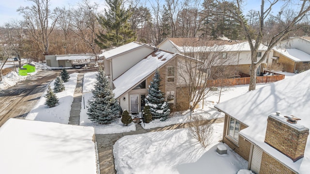 snow covered property featuring fence