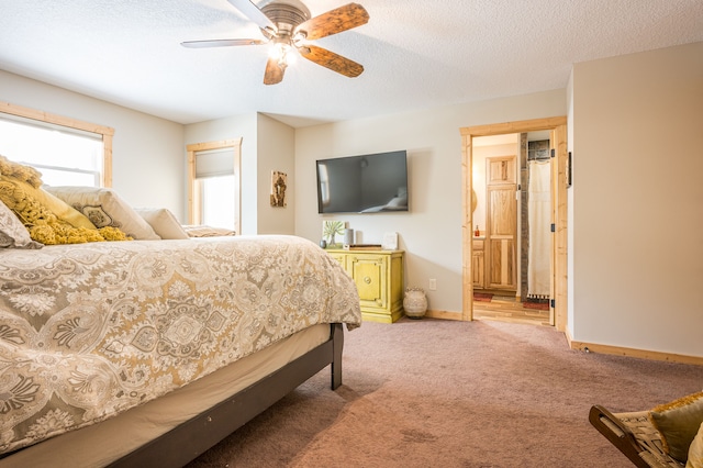 bedroom with baseboards, ceiling fan, ensuite bathroom, a textured ceiling, and light carpet