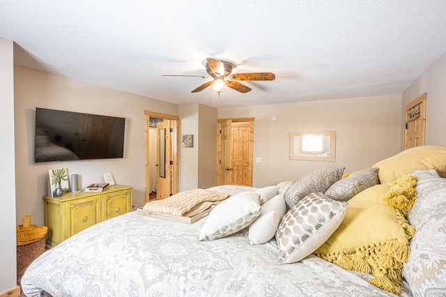 bedroom with a textured ceiling and a ceiling fan