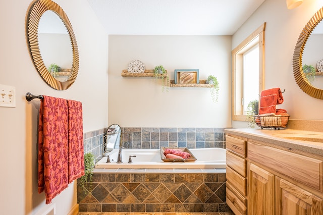 full bathroom featuring vanity and a garden tub