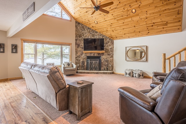 living room featuring baseboards, plenty of natural light, and a ceiling fan