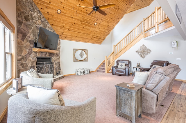 living area with a wealth of natural light, high vaulted ceiling, stairs, and ceiling fan