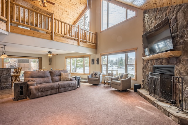 living room with carpet floors, wood ceiling, ceiling fan, and a fireplace