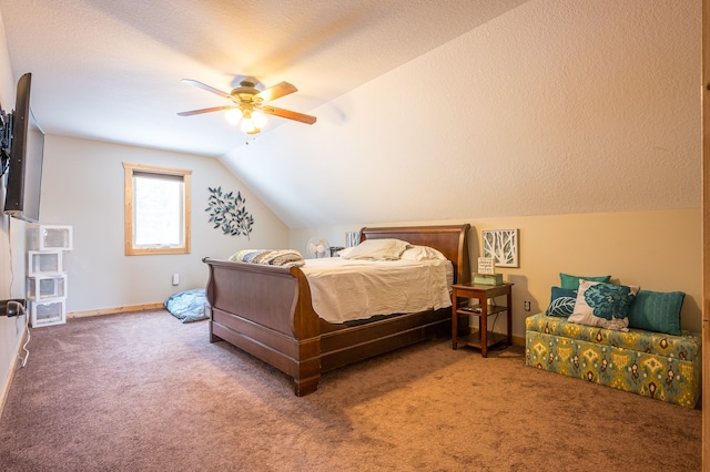 carpeted bedroom featuring baseboards, lofted ceiling, a textured ceiling, and a ceiling fan