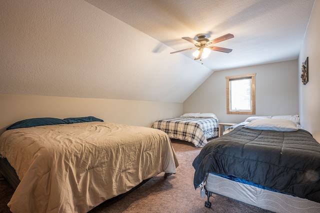 bedroom featuring a ceiling fan, vaulted ceiling, carpet, and a textured ceiling