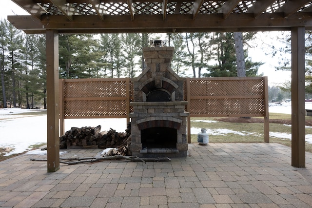 view of patio featuring a pergola and an outdoor stone fireplace