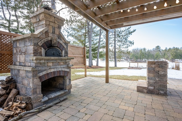 view of patio / terrace featuring an outdoor stone fireplace