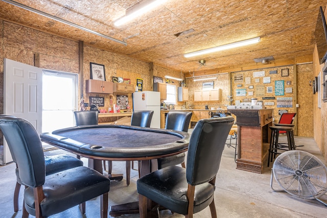 dining room with unfinished concrete floors