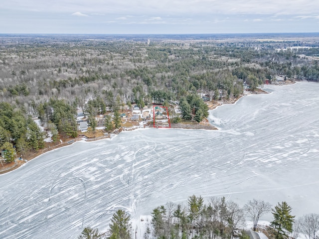 birds eye view of property with a wooded view