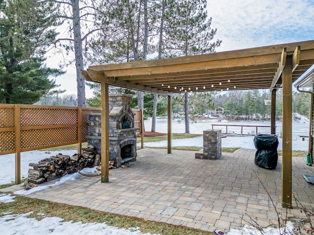 view of patio / terrace featuring an outdoor stone fireplace