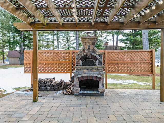 view of patio with a pergola and an outdoor stone fireplace