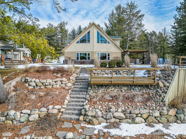 rear view of property with a wooden deck