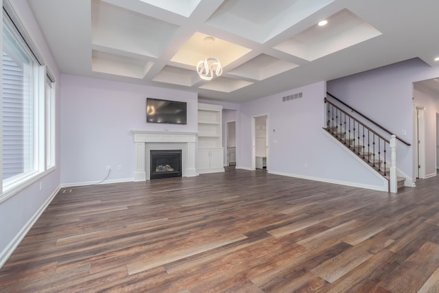 unfurnished living room featuring a fireplace, visible vents, baseboards, stairway, and an inviting chandelier