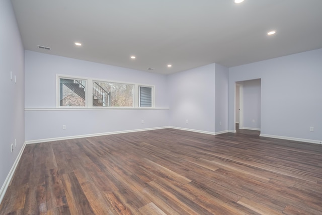 unfurnished room featuring dark wood-style floors, recessed lighting, visible vents, and baseboards