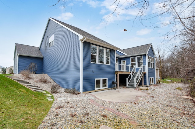 back of house with a patio, a shingled roof, stairway, a lawn, and a wooden deck