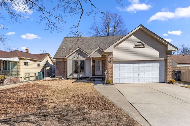 view of front of property featuring brick siding, driveway, a garage, and fence