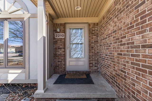 property entrance featuring brick siding