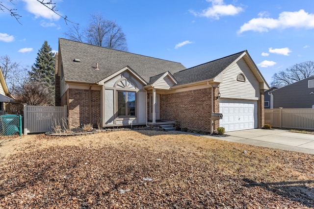 view of front of home with concrete driveway, fence, brick siding, and roof with shingles