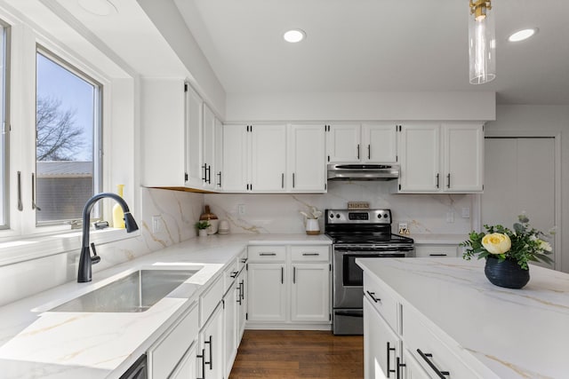 kitchen featuring under cabinet range hood, electric range, white cabinetry, and a sink