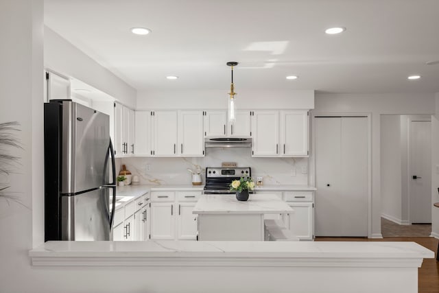 kitchen with tasteful backsplash, a kitchen island, range hood, stainless steel appliances, and white cabinetry