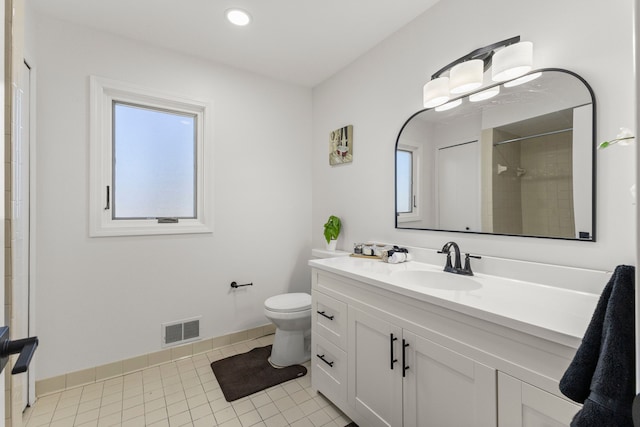 bathroom with vanity, tile patterned floors, baseboards, and visible vents