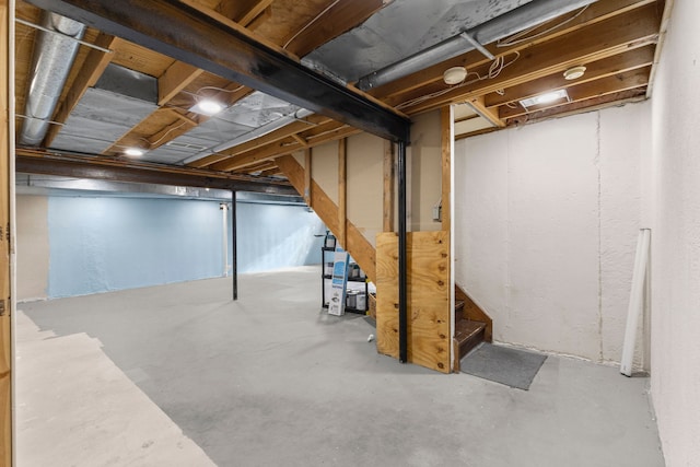 unfinished basement featuring stairs