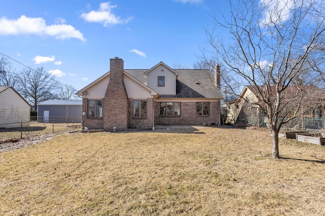 back of property featuring brick siding, a lawn, a chimney, and fence