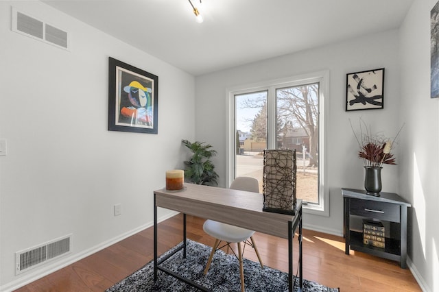 office space with light wood-style flooring, visible vents, and a wealth of natural light