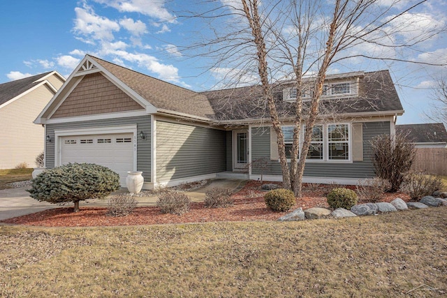 view of front facade featuring a garage, a shingled roof, and a front yard