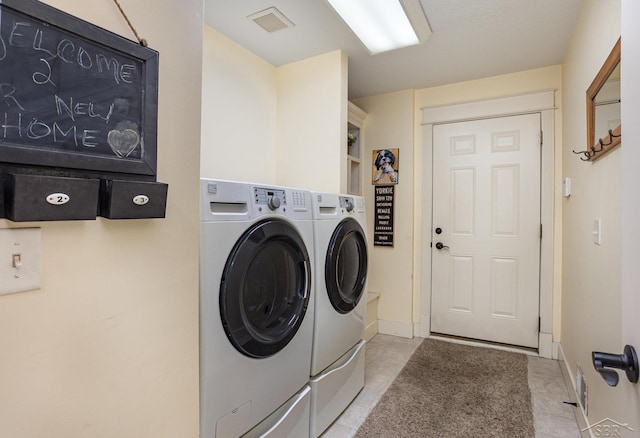 laundry room with laundry area, visible vents, separate washer and dryer, and light tile patterned flooring