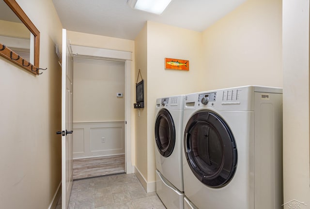 laundry area featuring baseboards, laundry area, and washer and dryer