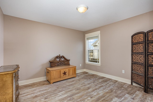 sitting room with light wood-type flooring and baseboards