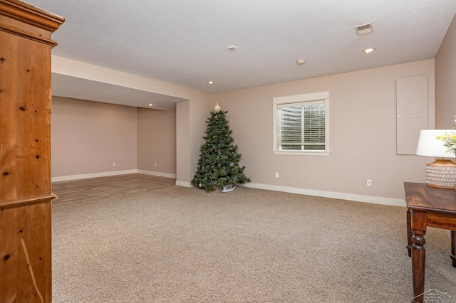 carpeted empty room featuring baseboards, visible vents, and recessed lighting