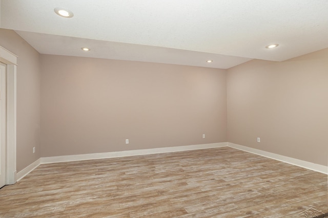 spare room featuring baseboards, light wood finished floors, and recessed lighting