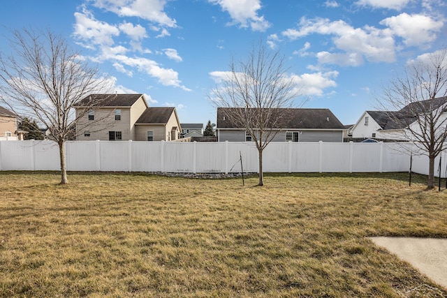 view of yard featuring a fenced backyard and a residential view