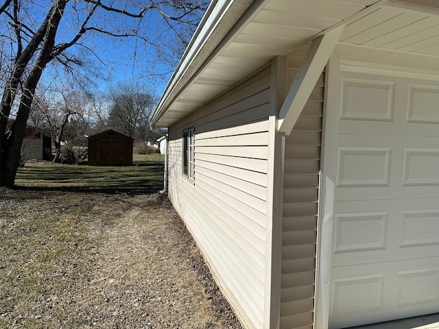 view of home's exterior with a storage unit, a garage, and an outdoor structure