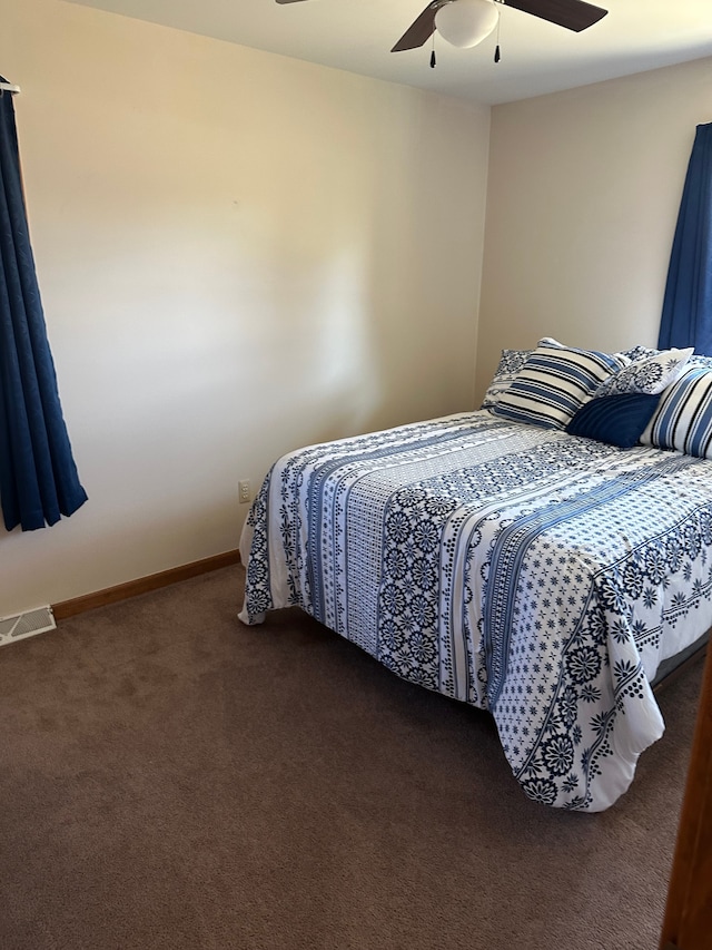 carpeted bedroom with a ceiling fan, baseboards, and visible vents