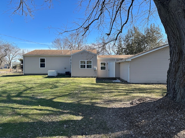 rear view of house featuring a lawn