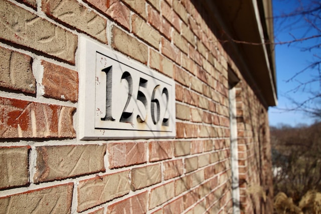 exterior details featuring brick siding