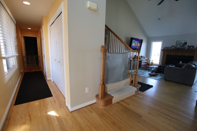 hallway featuring recessed lighting, stairway, baseboards, and wood finished floors