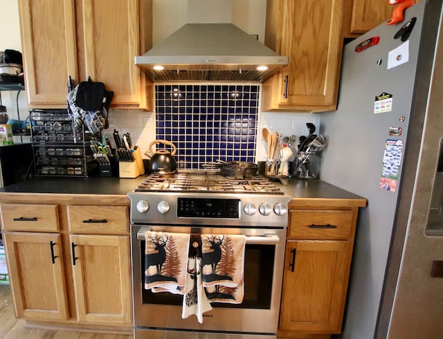 kitchen with dark countertops, decorative backsplash, appliances with stainless steel finishes, and exhaust hood