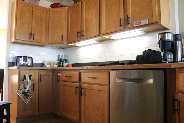 kitchen with tasteful backsplash and stainless steel dishwasher