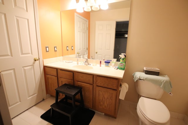 bathroom with vanity, tile patterned floors, toilet, and baseboards