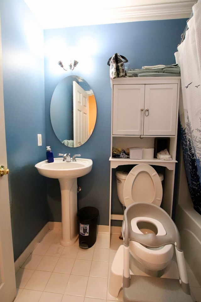 full bath featuring tile patterned floors, baseboards, and toilet