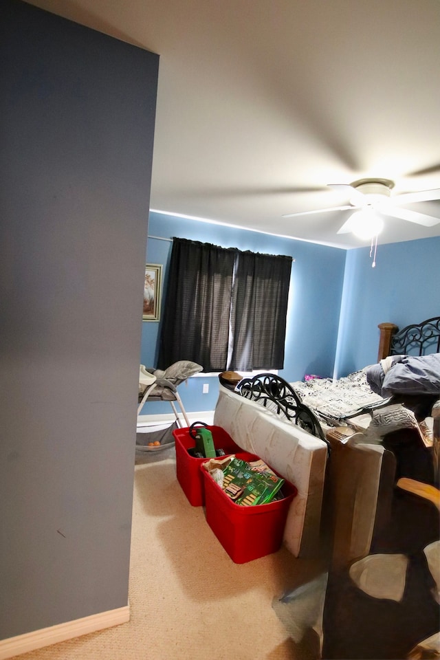 carpeted bedroom with baseboards and ceiling fan