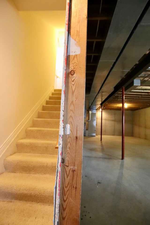 stairway with concrete flooring