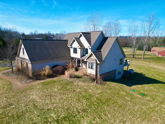 view of front of property with a front yard and roof with shingles