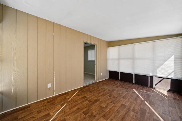 unfurnished room with wood finished floors