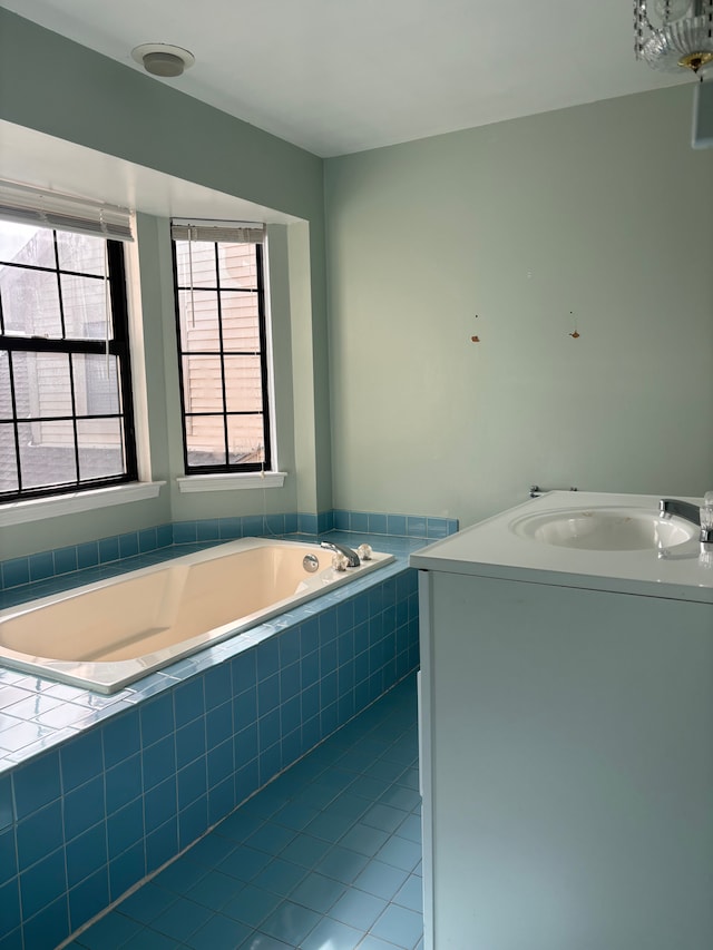 full bath with vanity, tile patterned floors, and a garden tub