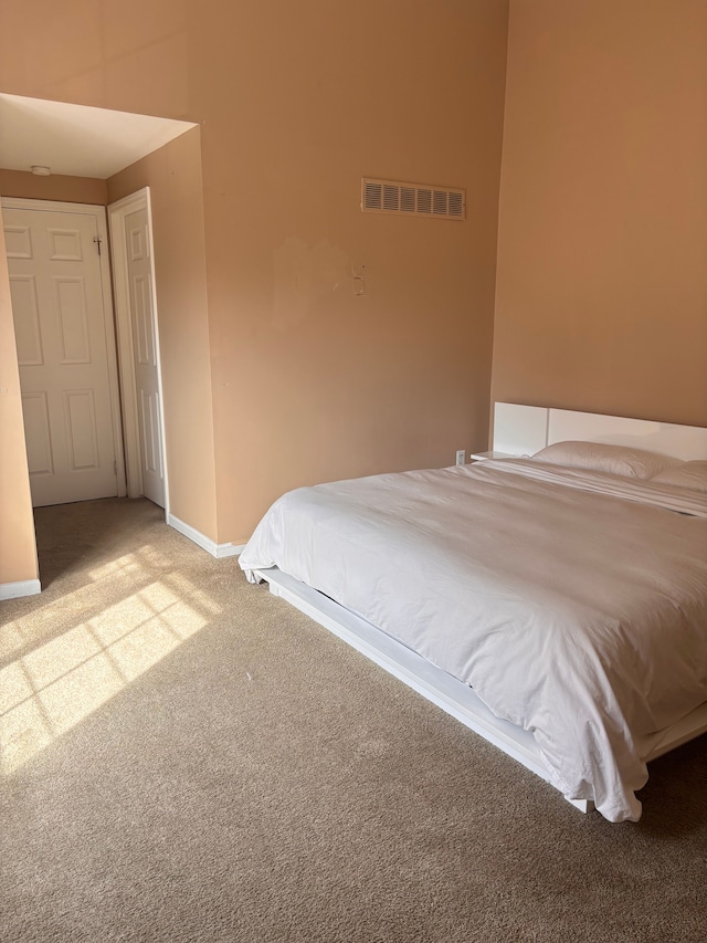 bedroom featuring visible vents, baseboards, and carpet floors